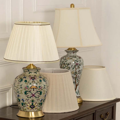 Classic table lamps with detailed floral bases and white fabric shades bringing warmth to a traditional and modern home decor setup.