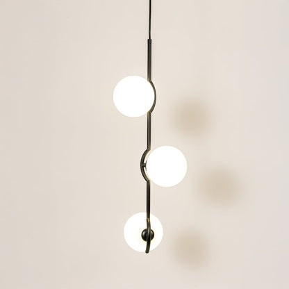 Elegant three-globe pendant light glowing softly on a clean white background featuring a sleek black frame and evenly spaced round shades.