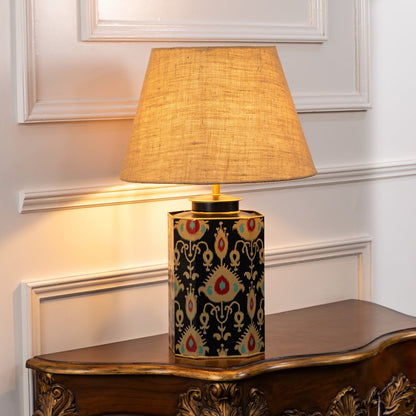 Bahari Ikat black table lamp illuminated on white background highlighting bold pattern warm glow and statement interior decor appeal.