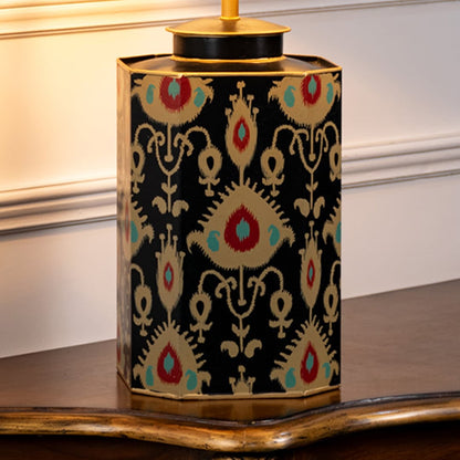Table lamp closeup featuring traditional multicolor motif on ceramic base with rich texture and decorative gold accent.