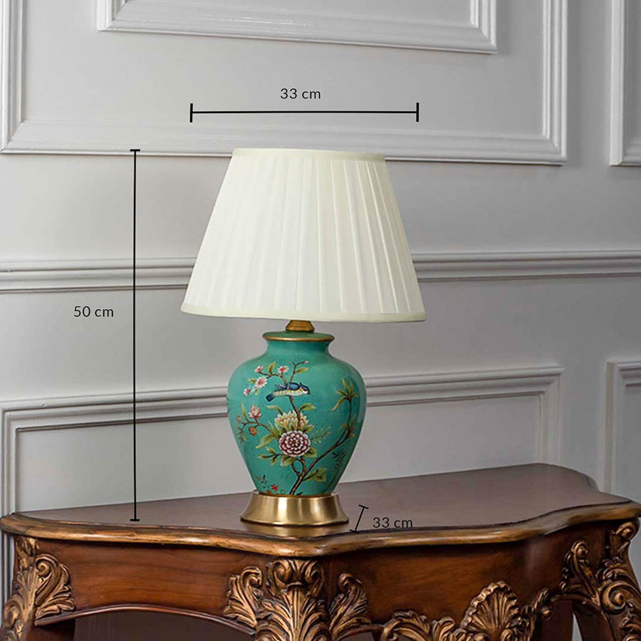 Green ceramic table lamp with floral hand-painted base and pleated fabric shade shown with 50cm height and 33cm width.