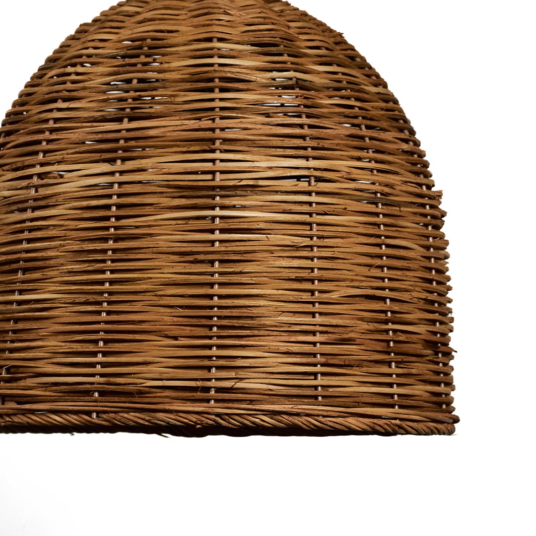 Closeup of handwoven rattan pendant light showcasing intricate weaving and smooth dome-shaped texture.