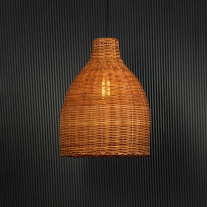 Brown rattan pendant light with handwoven bamboo shade turned on glowing softly against plain black background.