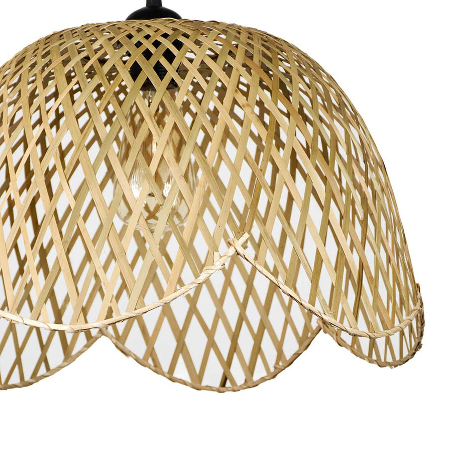 Closeup of scalloped beige rattan pendant light showcasing handcrafted weave and timeless design style.