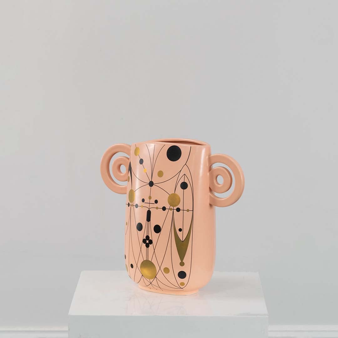 Peach abstract ceramic vase with decorative loop handles shown on a clean white background ideal for modern stylish decor.