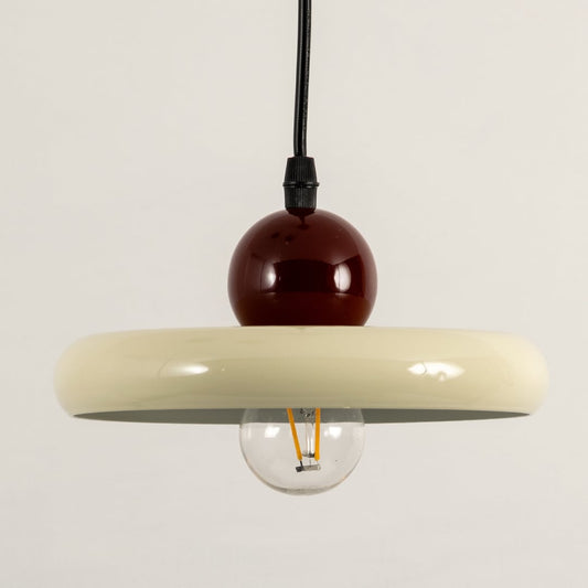 Cream metal pendant light with burgundy accent illuminated to display stylish modern decorative ceiling lighting.