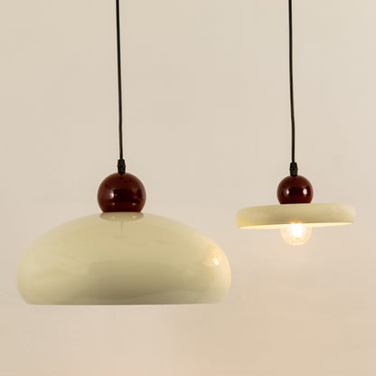 Minimal burgundy and cream pendant lights for contemporary dining room and luxury interior decor styling.