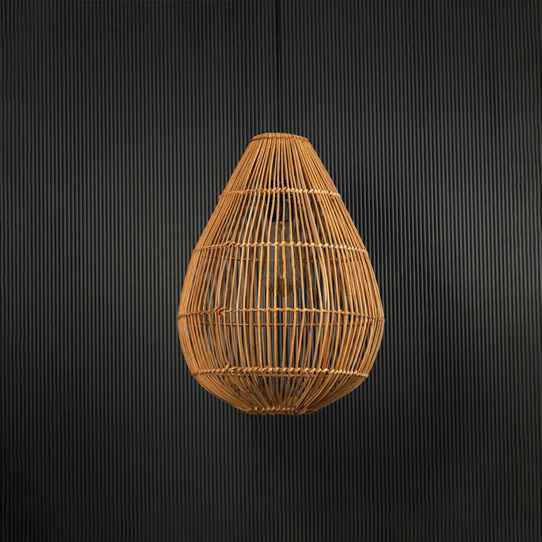 Rattan pendant light on black background highlighting elegant teardrop shape and natural craftsmanship.