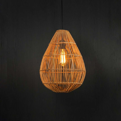 Teardrop rattan pendant light glowing softly on black background with warm ambient illumination.