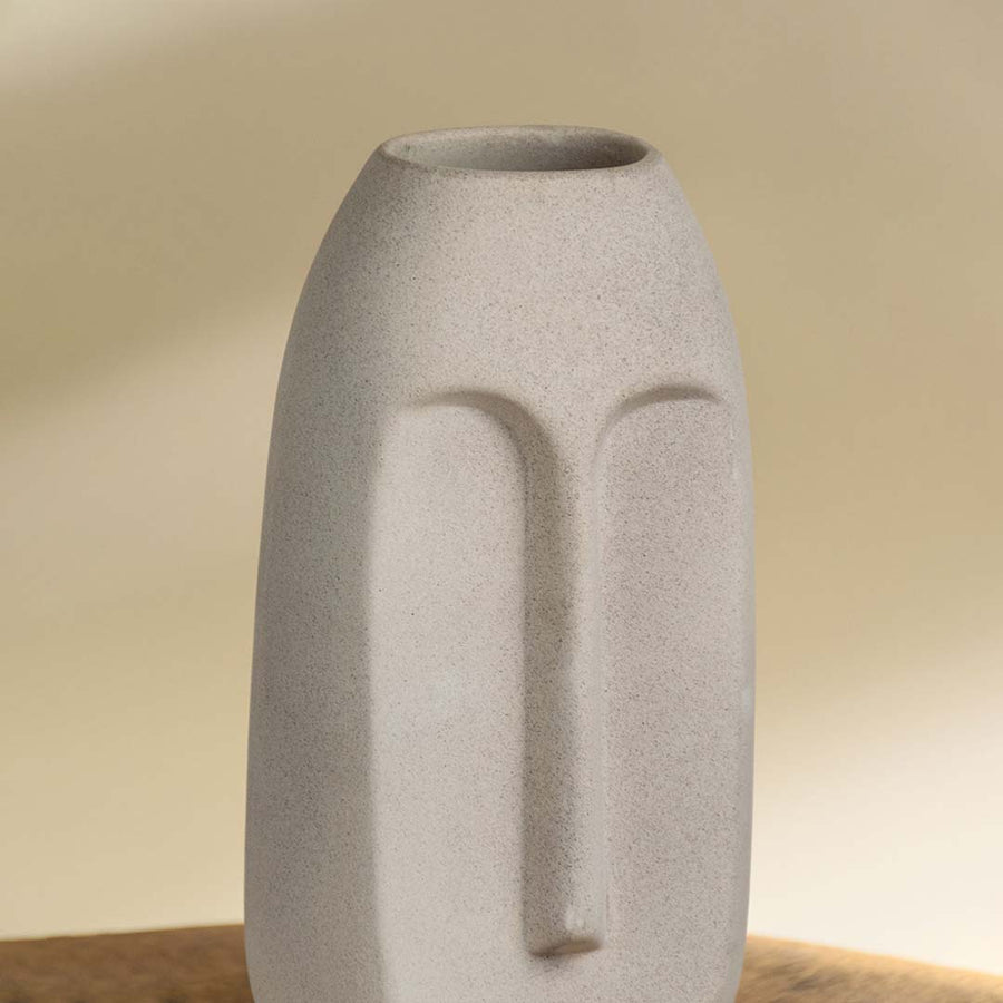 White ceramic decorative vase with sculptural arch pattern for elegant shelf styling and contemporary home decor.
