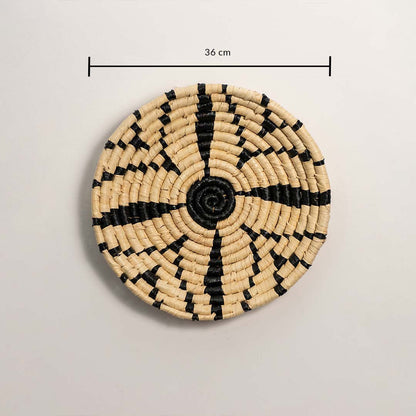 A handwoven natural and black rattan wall decor plate displayed on a white background with a clearly marked diameter of 36 cm for accurate wall decor measurements.