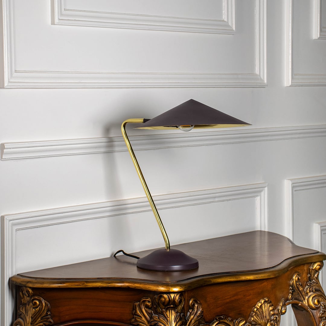 Gold metal table lamp with dark brown conical shade displayed off on white background highlighting elegant minimalist style.