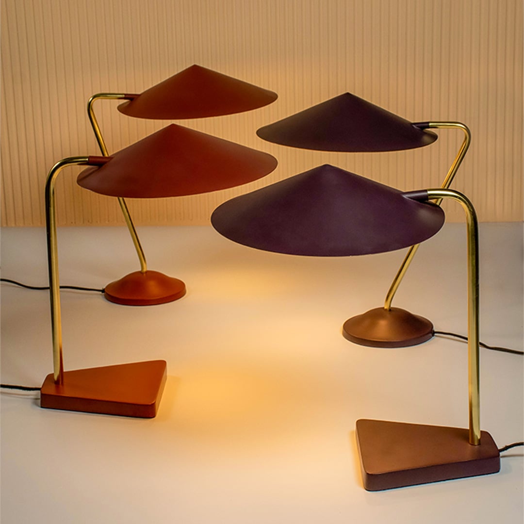 Gold metal table lamp with terracotta brown shade displayed together in a styled setup for modern decorative tabletop lighting.
