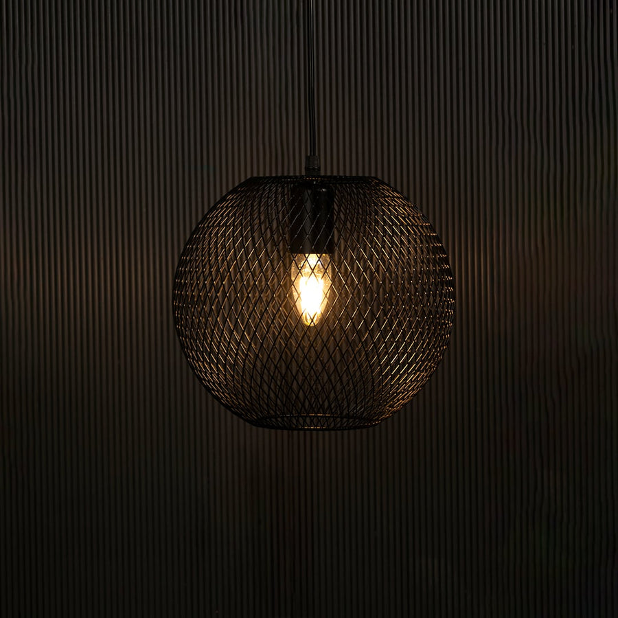Elegant black metal pendant light illuminated on dark background highlighting intricate mesh detailing and modern industrial style.
