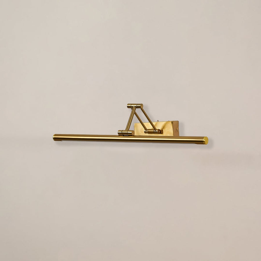Gold adjustable picture light with light off shown on white background perfect for art walls living rooms and gallery style decor.