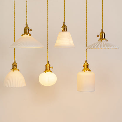 Modern pendant light set in gold metal finish with varied glass shades for dining room or kitchen decor lighting grouped image.