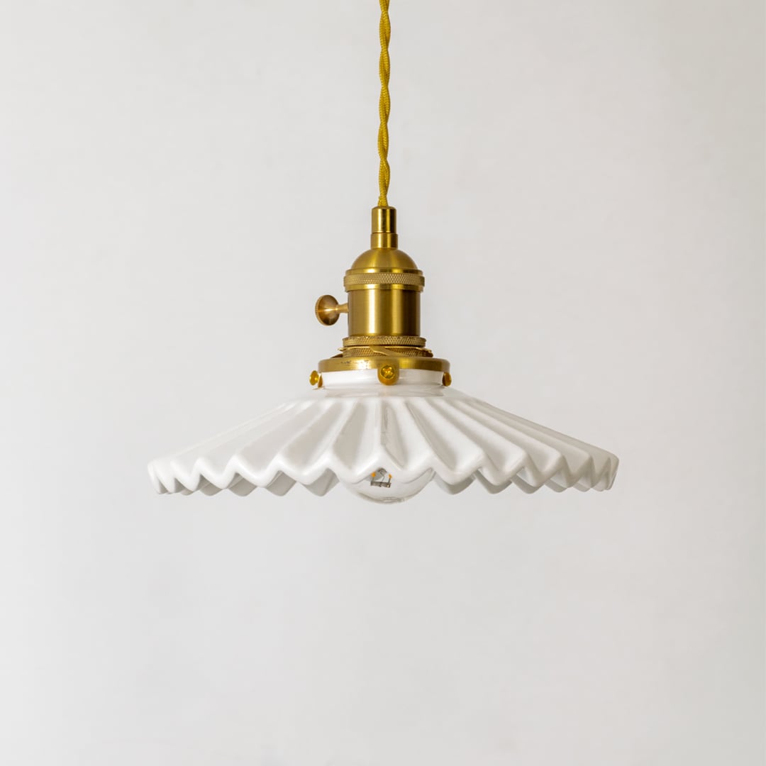 White ceramic and gold metal pendant light showcasing artistic craftsmanship for modern spaces.