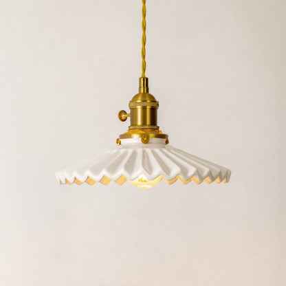 Collection of white ceramic and gold metal pendant lights for stylish modern home lighting decor.