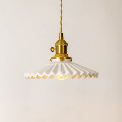 Collection of white ceramic and gold metal pendant lights for stylish modern home lighting decor.