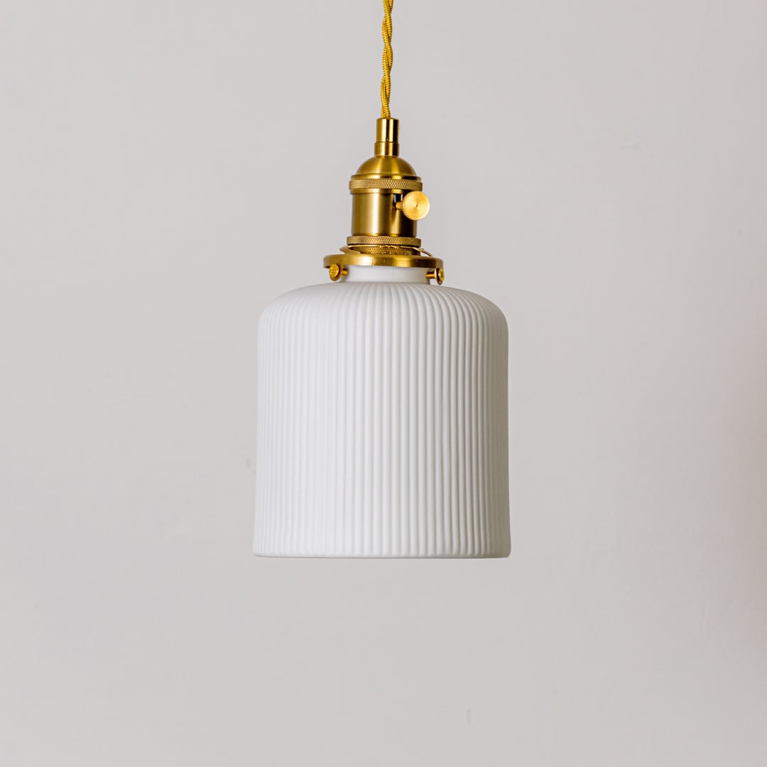 Ribbed white glass pendant light with gold metal holder shown on white background for modern home interior decor.
