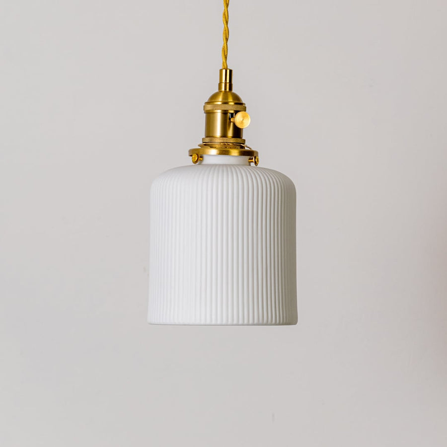 Ribbed white glass pendant light with gold metal holder shown on white background for modern home interior decor.
