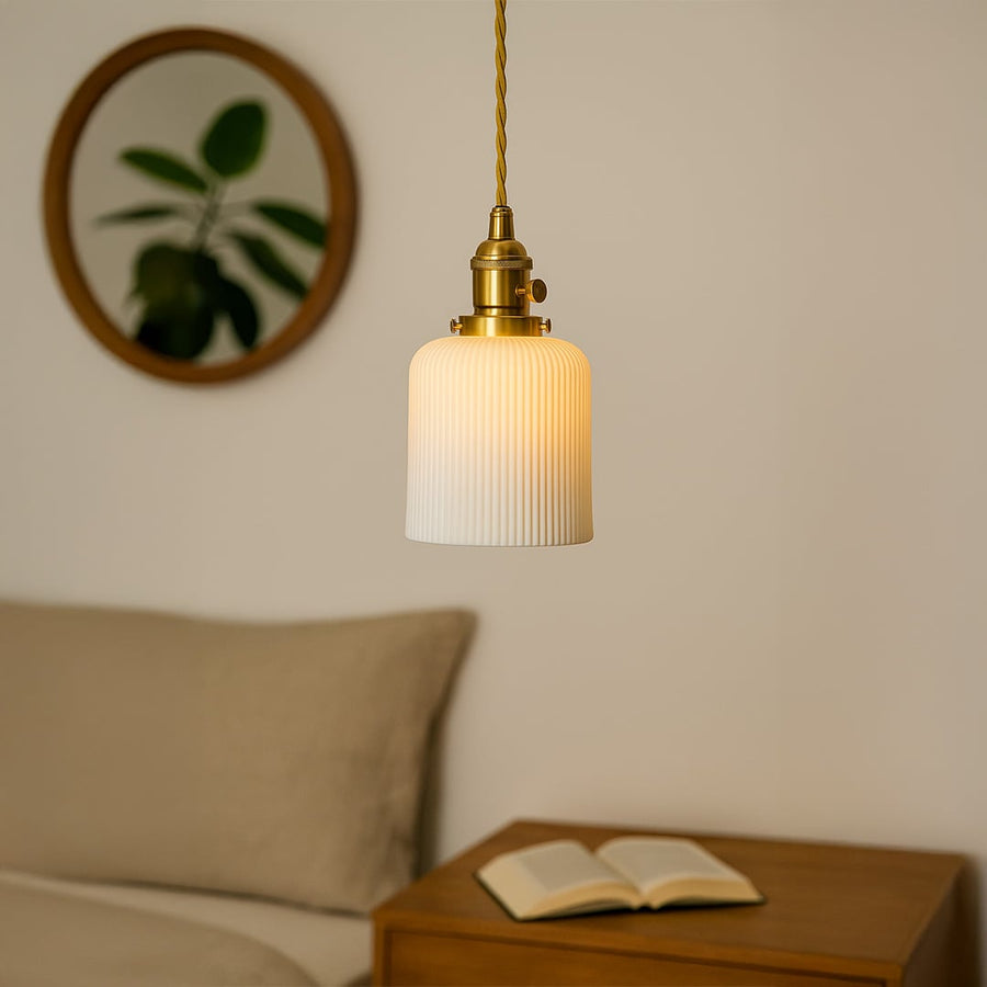 Ribbed white glass pendant light with gold metal holder adding modern elegance to living room dining room and home decor.