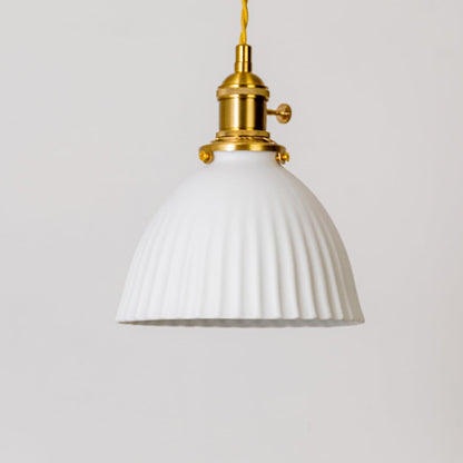 Closeup of fluted white glass pendant light showing detailed ribbed shade and gold metal holder for elegant home interior decor.