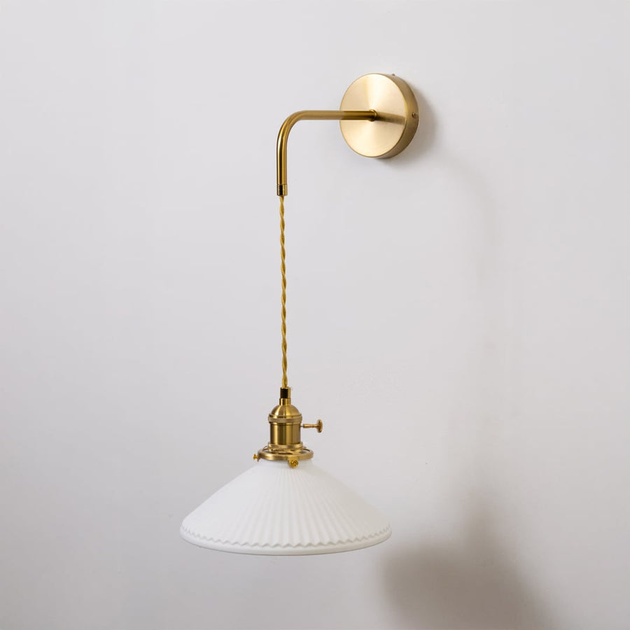 Gold metal wall light with white ribbed shade shown switched off on white background for minimal stylish wall decor.