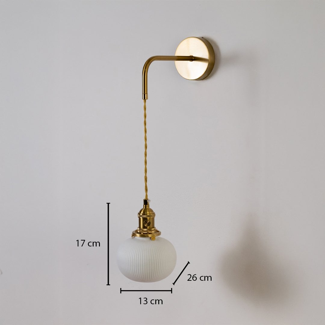 Gold wall light with ribbed globe shade shown with 17 cm shade height 13 cm width and 26 cm depth for accurate placement.