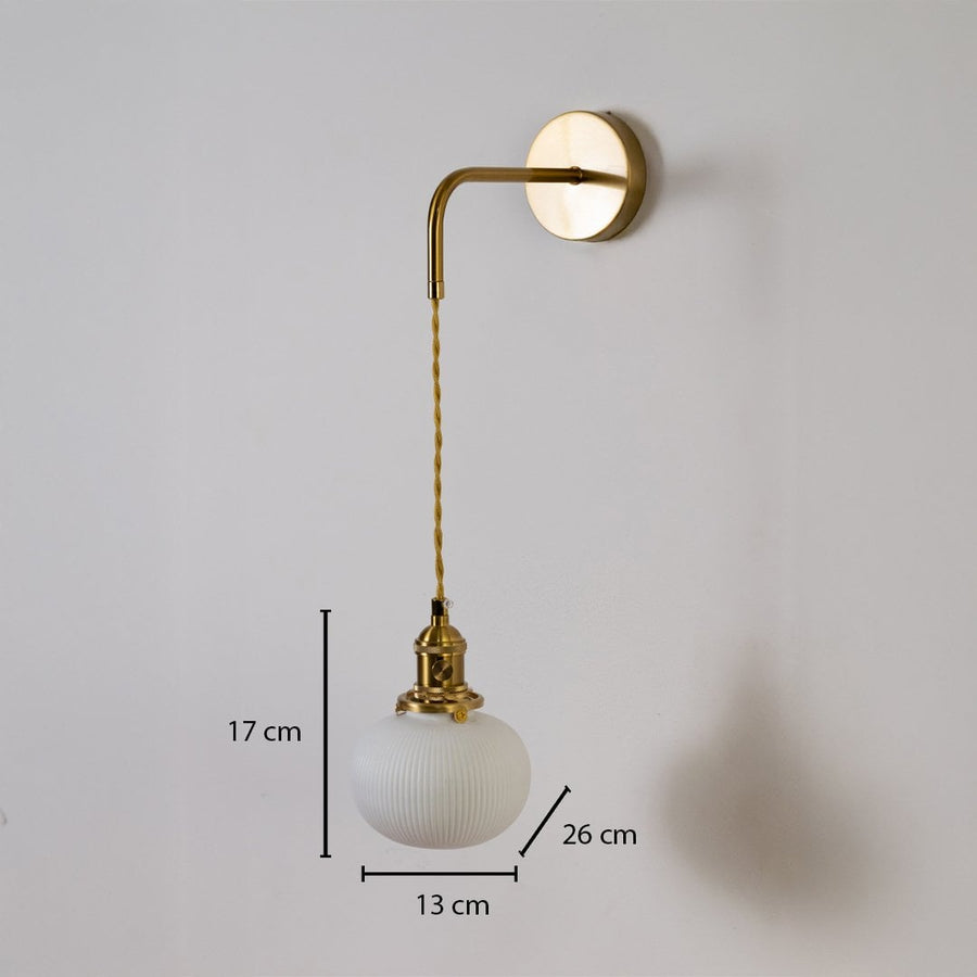 Gold wall light with ribbed globe shade shown with 17 cm shade height 13 cm width and 26 cm depth for accurate placement.