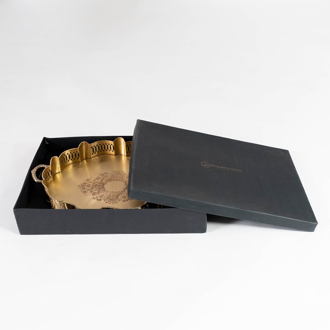 Elegant gold brass tray in premium black gift box with lid partially open showcasing ideal packaging for gifting purposes.