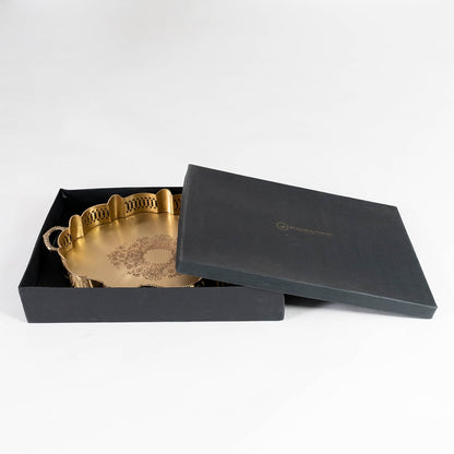 Elegant gold brass tray in premium black gift box with lid partially open showcasing ideal packaging for gifting purposes.