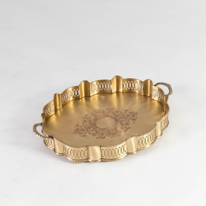 Round gold brass serving tray with ornate edge and floral center engraving photographed on white background for clarity.