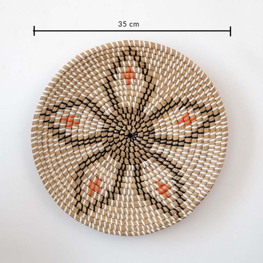 Round wicker wall plate decor measuring 35 cm with handwoven natural beige black and orange design on white background.
