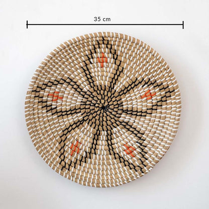Round wicker wall plate decor measuring 35 cm with handwoven natural beige black and orange design on white background.