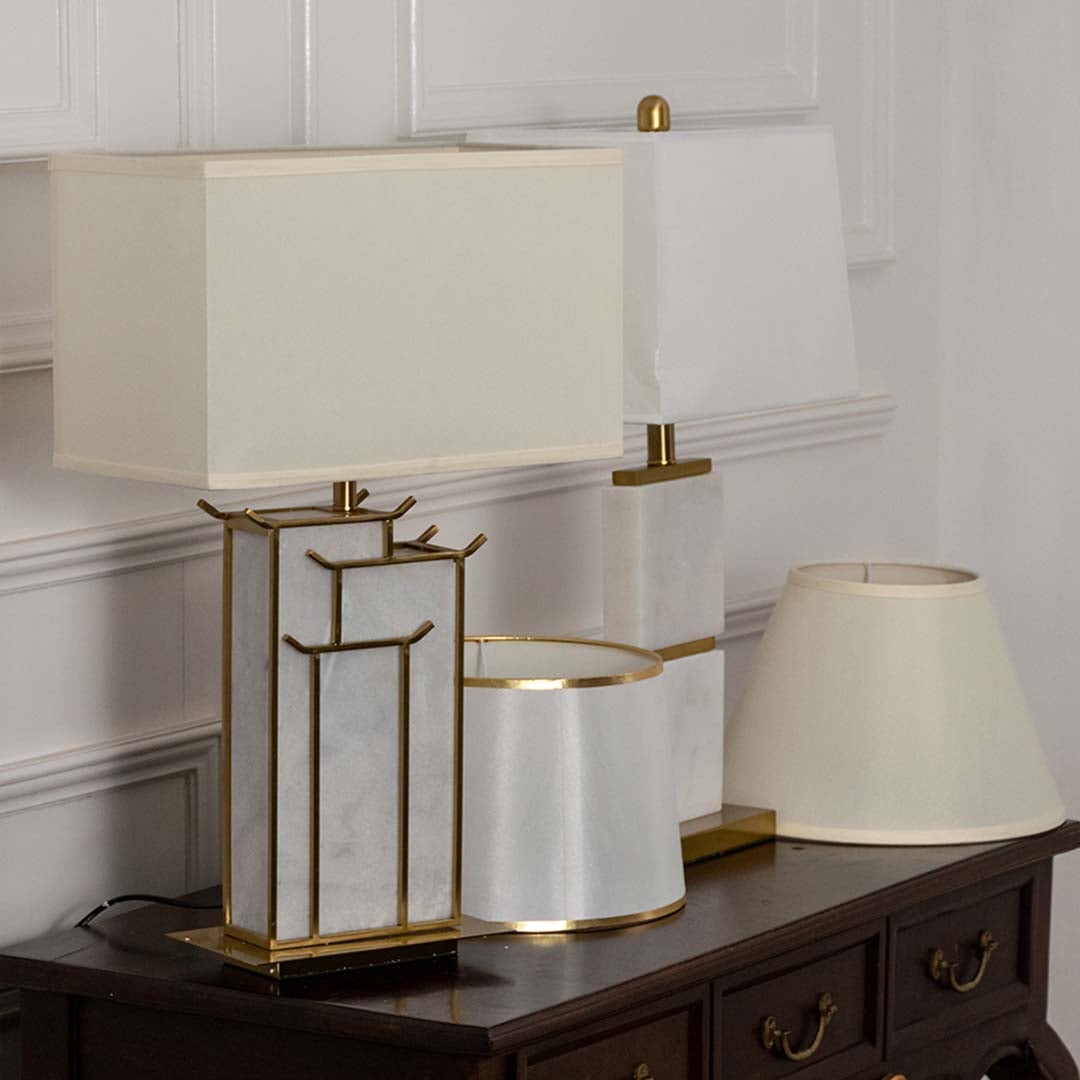 White shade gold lattice table lamp on wooden console table with light off for decorative luxury home décor.