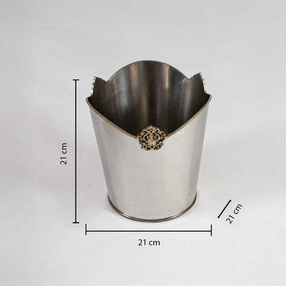 Stainless steel bin with 27 cm height 21 cm width and 20 cm depth shown with gold crest detail and rounded base.