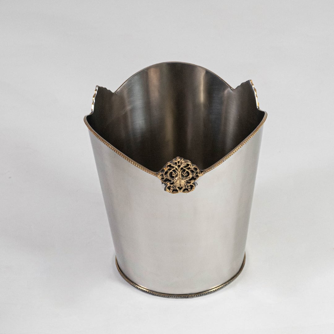Decorative silver metal bin with ornate gold accent and high back curve shown from top front on white background.