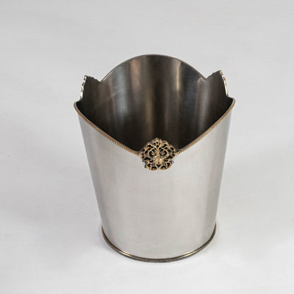 Decorative silver metal bin with ornate gold accent and high back curve shown from top front on white background.