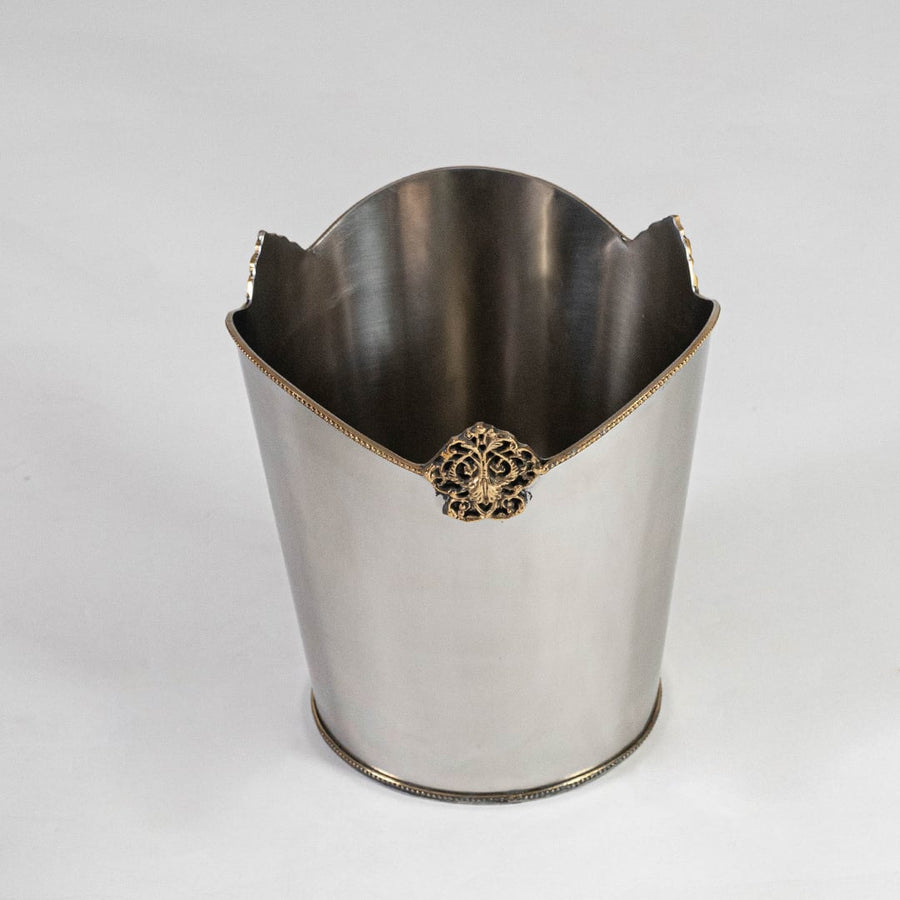 Decorative silver metal bin with ornate gold accent and high back curve shown from top front on white background.