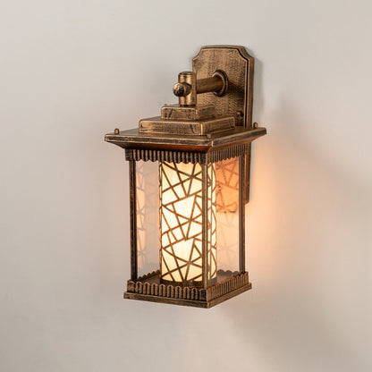 Antique brass outdoor wall light on white background with mosaic pattern inner glass cylinder shade for entryway decor.
