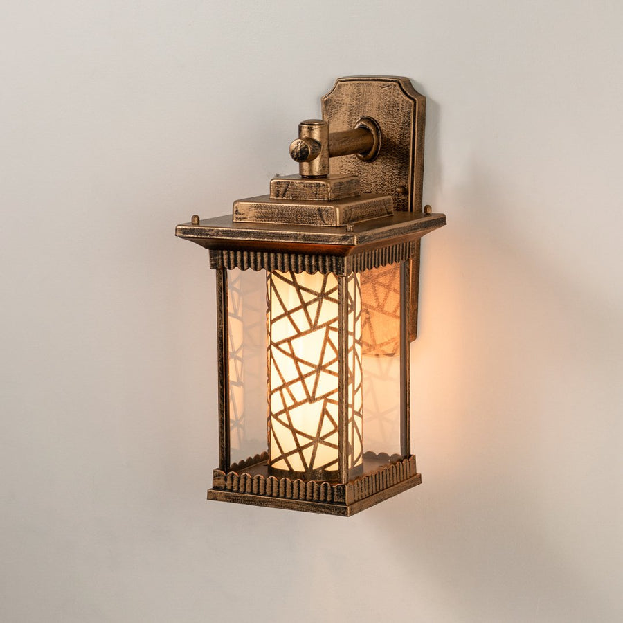 Antique brass outdoor wall light on white background with mosaic pattern inner glass cylinder shade for entryway decor.