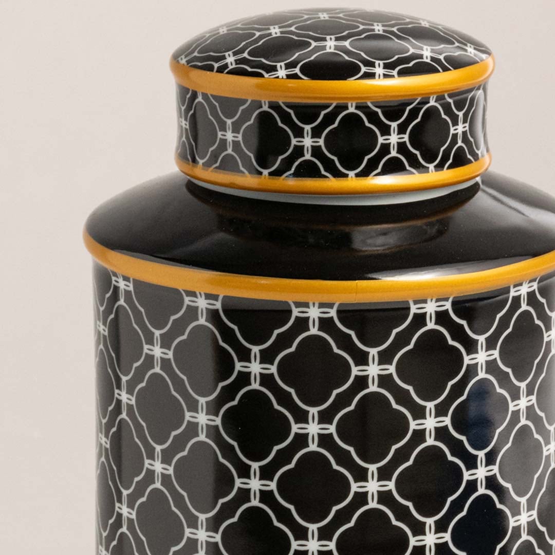 Detailed view of ceramic jar surface showcasing glossy finish with white trellis pattern and golden rim.