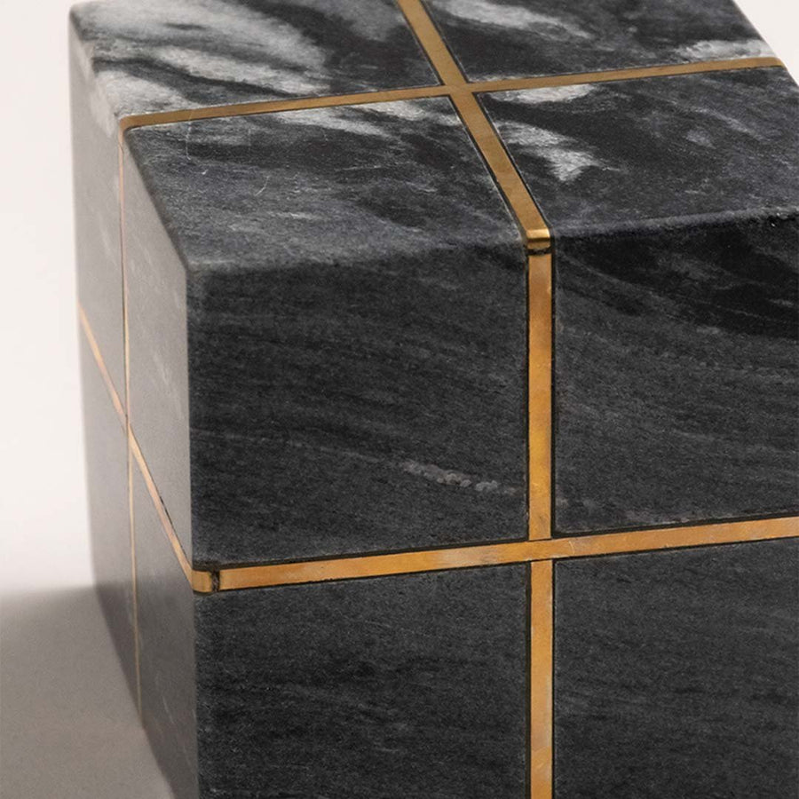 Closeup of black marble decorative storage box with gold metal detailing highlighting luxury craftsmanship and design.