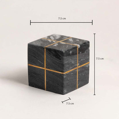 Black marble cube with gold accents showing 7.5 cm height width and depth dimensions.