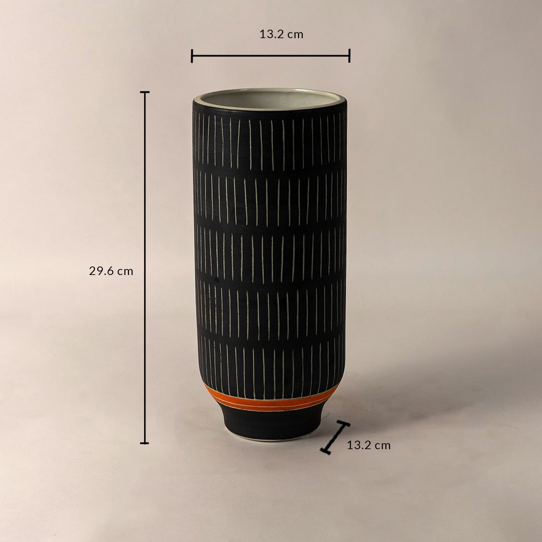 Black ceramic vase with white striped design and orange accent shown with 29.6 cm height and 13.2 cm diameter dimensions.