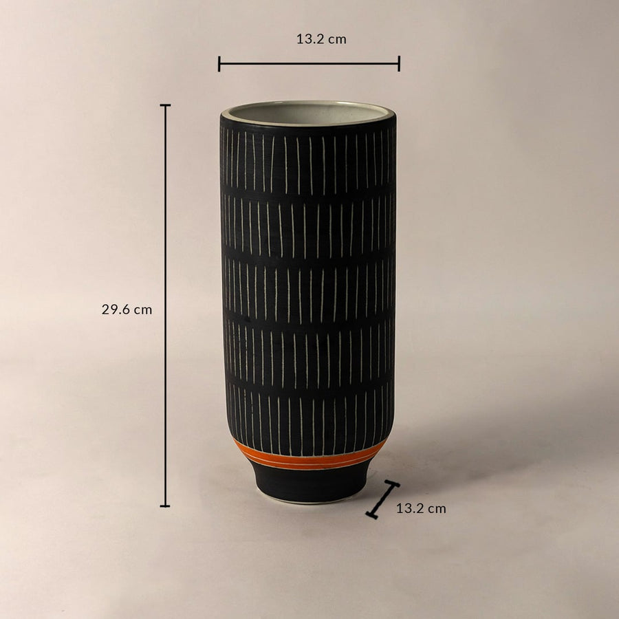 Black ceramic vase with white striped design and orange accent shown with 29.6 cm height and 13.2 cm diameter dimensions.