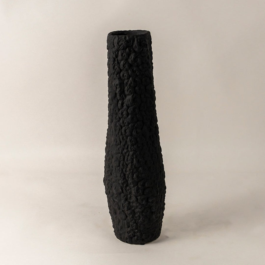 Contemporary tall black ceramic vase with handcrafted textured finish styled for minimal living room and office interiors.