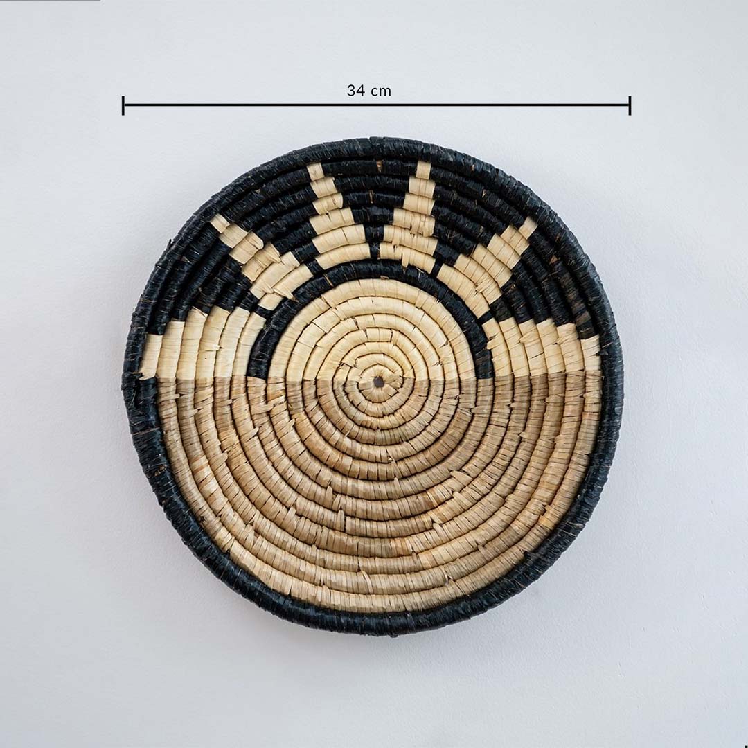 Handwoven round wall basket in natural and black fiber showing 30 cm diameter suitable for decorative interior wall placement.