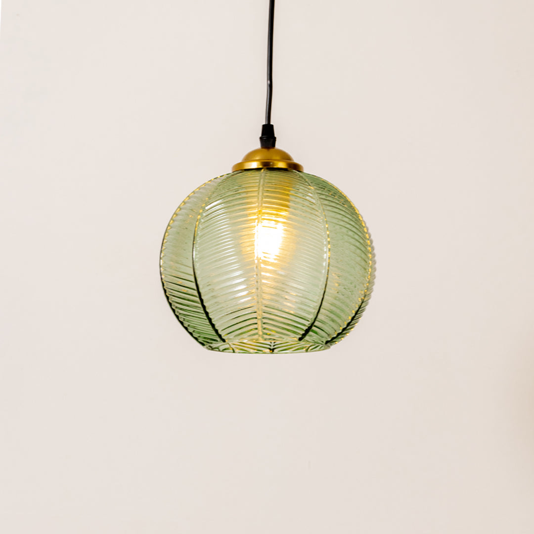 Contemporary pendant light in gold metal finish with green glass shade for dining room or kitchen decor lighting white background.